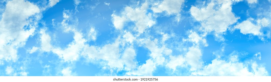white fluffy clouds on a sky blue sky background in high resolution