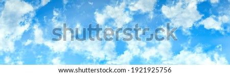 white fluffy clouds on a sky blue sky background in high resolution