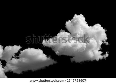 white fluffy clouds standing out against a black background
