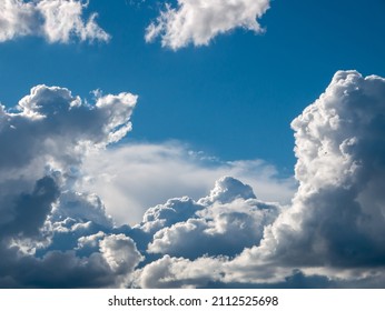 White Fluffy Epic Clouds On Blue Sky