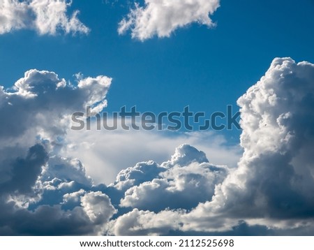 White fluffy epic clouds on blue sky