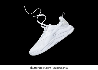 White flying sneakers isolated on black background - Shutterstock ID 2185083453