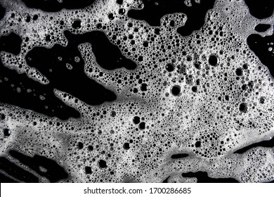 White Foam Bubbles On A Black Background