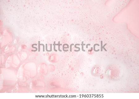 White foam bubbles texture on pink pastel background, copy space, banner for loundry, cleaning service, bathroom concept, clean, wash - liquid soap, shower gel, shampoo