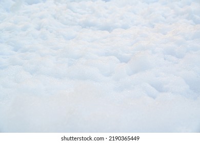 White Foam For Foam Party. Dancing To Music On A Dance Floor Covered With A Few Feet Of Foam Or Bubbles Emitted From The Foaming Agent. Background And Texture.