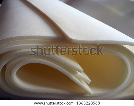White foam rubber rolls. Textured foam materials. Rolled soft protection material for building