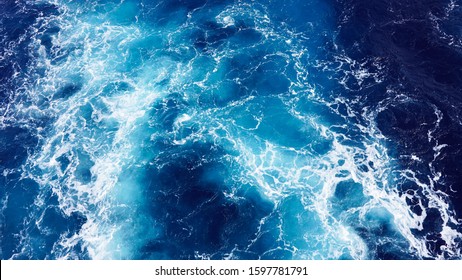 White foam sea wave. sea ​​foam in the Pacific Ocean, the bright color of the water is turquoise, blue. deep marine texture. dark clear water in the ocean - Shutterstock ID 1597781791