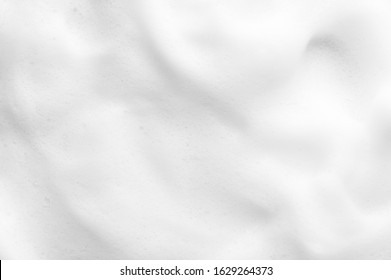 White foam texture close up background. Soapy substance with bubbles backdrop. Creamy grainy macro. Shower gel, washing liquid smears wallpaper. Cosmetic product foamy smudges top view - Shutterstock ID 1629264373