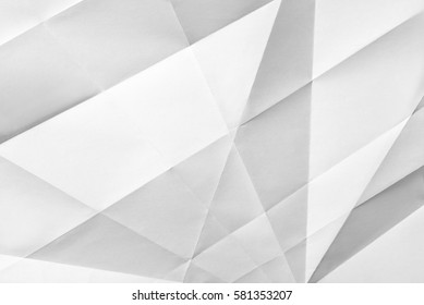 White Folded Sheet Of Paper Showing An Abstract Texture Design Under The Light Grazing. Good To Use As Background