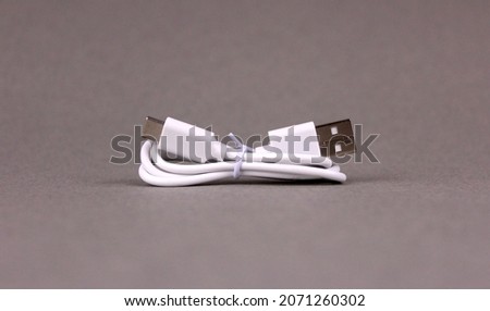 White folded usb and micro usb cable on gray background