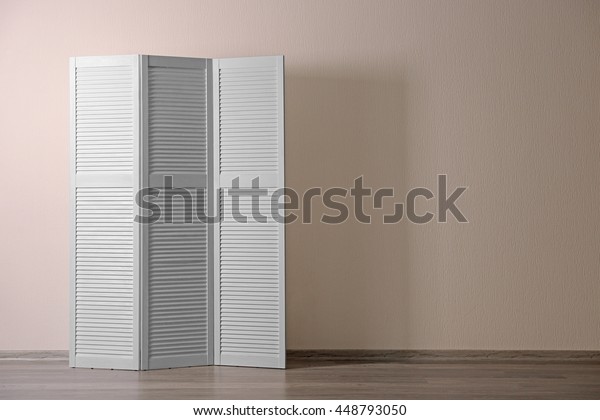 White folding screen in\
room
