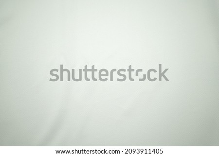 White football jersey clothing fabric texture sports wear background, close up. Sport Clothing Fabric Texture Background. Top View of Cloth Textile Surface. White Football Shirt. 