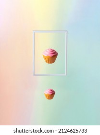 White Frame And Cupcakes On Colorful Background. Creative Mirror Concept. Small And Big Cake Composition. Modern Sweets Idea. 3d Illustration.