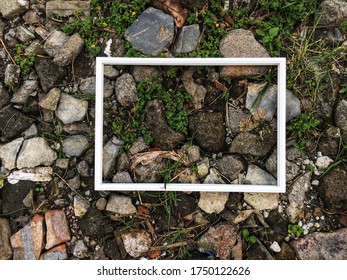 White Frame Isolated On Greenery And Stone Background