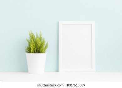 White Frame Mock Up On A Book Shelf And A Houseplant. Blue Color.