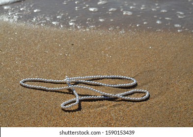 
White Freshwater Pearl Necklace On The Beach Shore