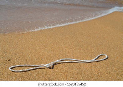 
White Freshwater Pearl Necklace On The Beach Shore