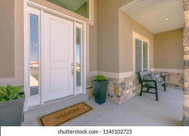 White Front Door With Welcome Mat On Patio