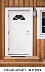 White Front Door In A Wooden Building