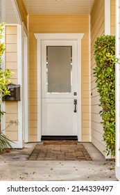 White Front Door And Yellow Painted Home Exterior