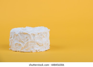 White Frosted Cake On Yellow Background