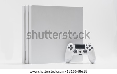White game console and controller on with background