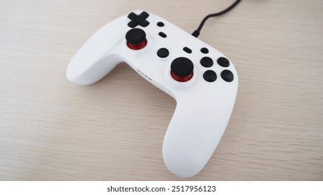 White game controller on wooden table - Powered by Shutterstock