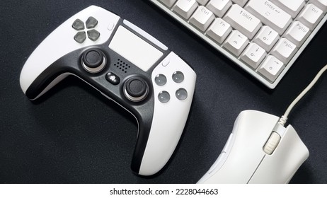 white gaming controller and white gaming mouse keyboard