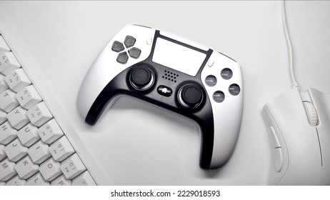 white gaming controller and white gaming mouse keyboard