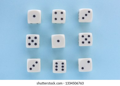 White gaming dices on light blue background. victory chance, lucky. Flat lay, place for text. Top view. Close-up. Concept gamble.