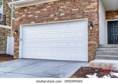 White Garage Door Adjacent To Stairs Going Up To The Front Door Door Of House