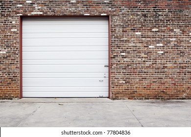 White Garage Door On Brick Wall