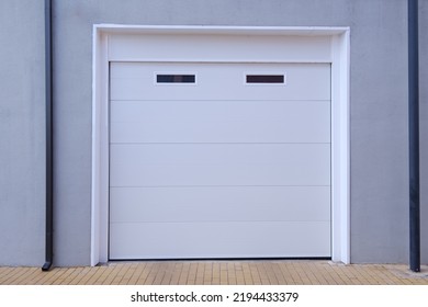 White Garage Door With Two Small Windows On The Upper Part