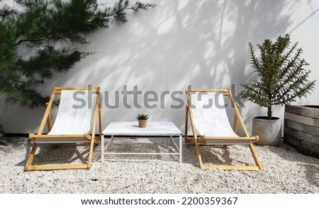 White Garden chair on stone ground in the garden park and outdoor -  exterior design vintage style - relax and chilling vibe - image from Bangkok thailand