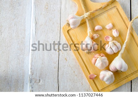 White garlic on wood
