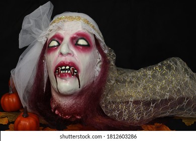 The White Gaze Of A Vampire Woman On A Black Background