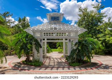 A White Gazebo Among Tropical Plants In Cypress Grove Park, Orlando, Florida.