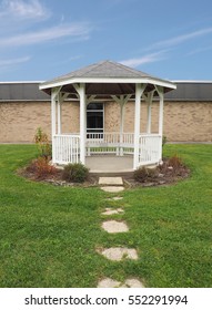 White Gazebo By A Brick Building