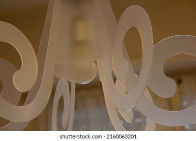 White Geometric Chandelier Hanging From The Ceiling.