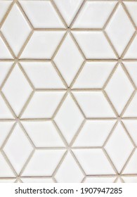 White, Geometric Patterned Wall Tile With Beige Colored Grout Visually Creates An Illusion Of Multiple 3-D Cubes. Photo Is Vertical Orientation.