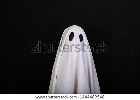White Ghost on black background. Halloween holiday party