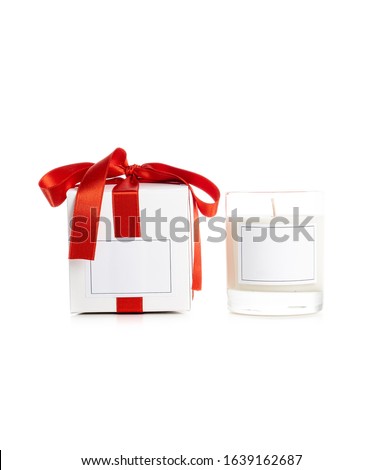 White gift box with empty lable and red satin ribbon with candle, isolated on white background