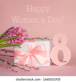 White Gift Box With Pink Ribbon, Hyacinth Flower, Pussy-willow Twigs And Number 8 On Pink Background With Text. Happy International Women's Day March 8 Greeting Card. Square Image.