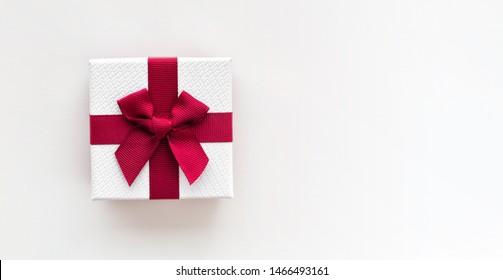 White Gift Box With Red Ribbon Isolated On White Background. Top View.
