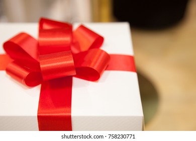 White Gift Box Tied With Elegant Red Ribbon. Shoot From Close Up, Waiting For The Festival Day At The End Of The Year And Can Used In Various Festivals.
