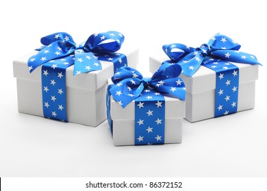 White Gift Boxes With Blue Ribbon.