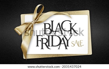 White gift card with golden ribbon bow and black friday sale text, isolated on black background template with copy space for promotional offer