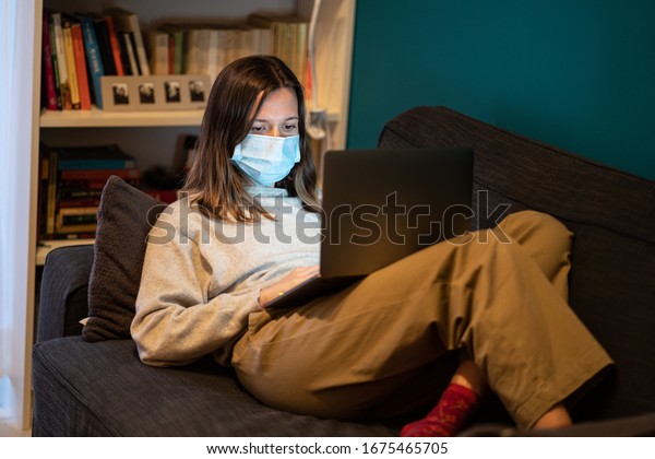 A white girl is\
working from home during Coronavirus or Covid-19 quarantine,\
coronavirus covid 19 infected patient in coronavirus covid 19\
quarantine room using\
computer