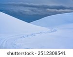 White glacier mountain with snow covered and snowmobile track on summit in winter at Iceland