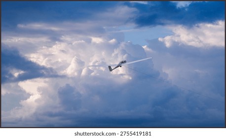 White glider plane soaring through a vibrant blue sky with soft white clouds, captured during a peaceful recreational flight on a bright sunny day.